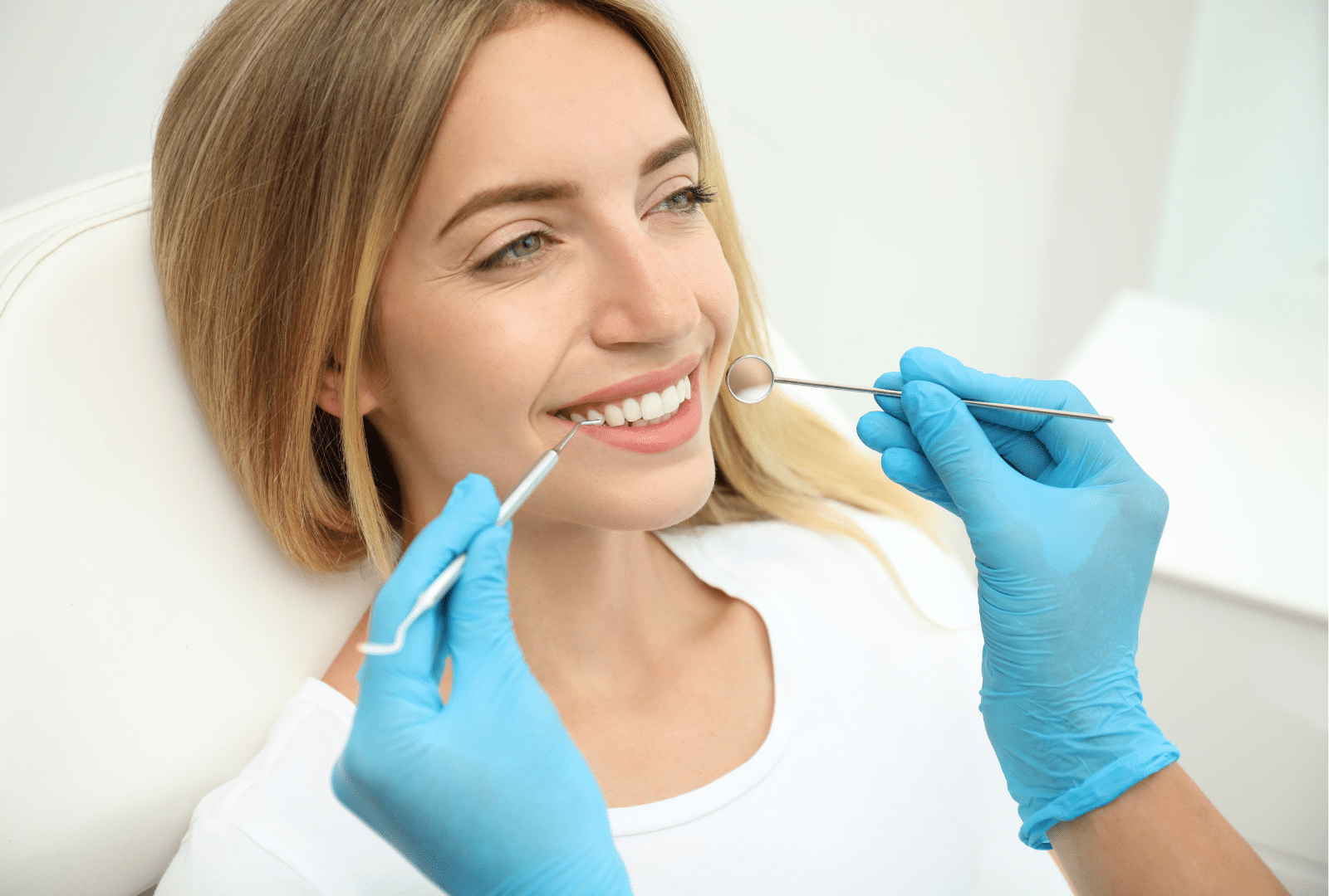 Patiente souriante lors d’un examen en clinique de dentisterie esthétique.